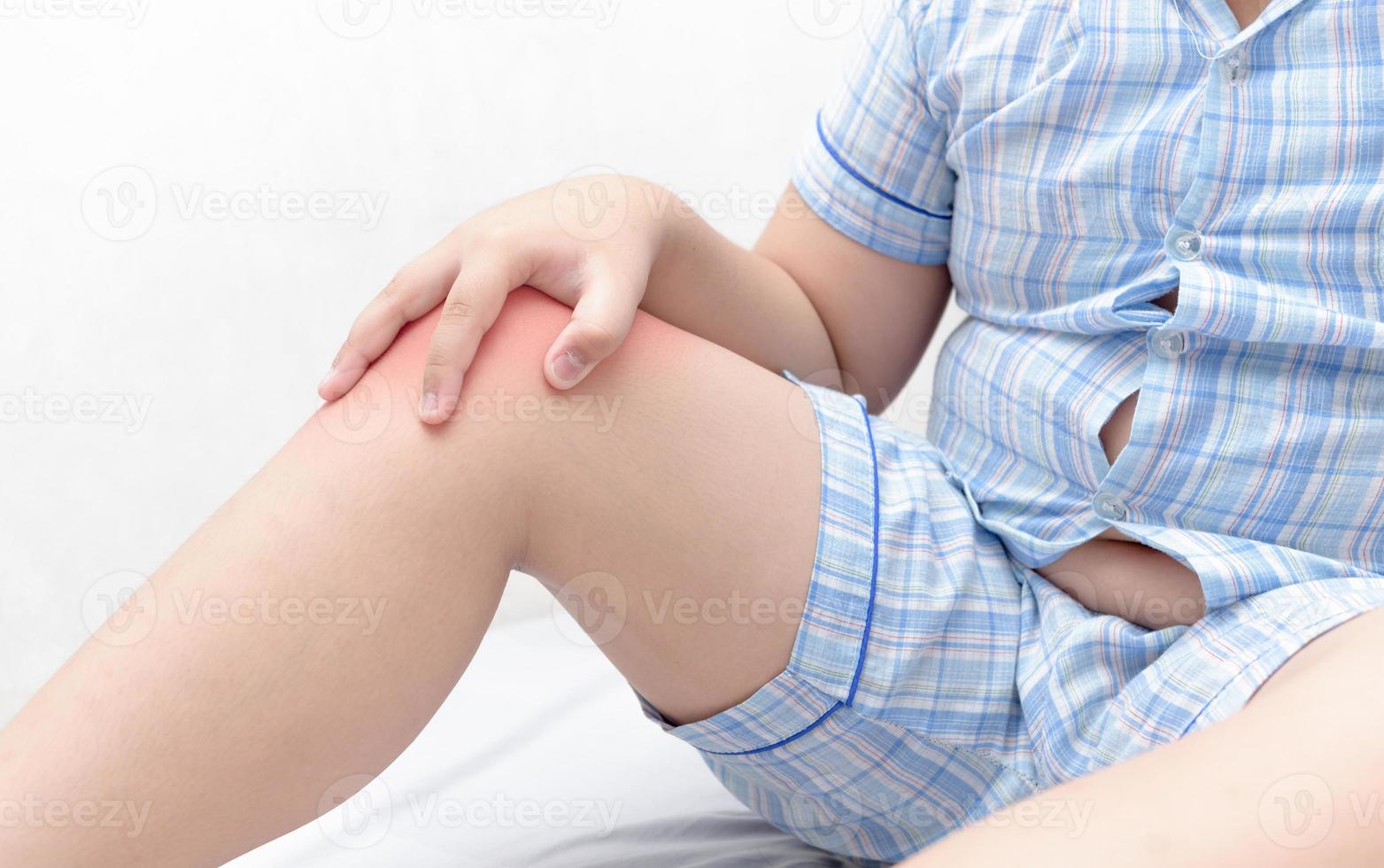 Leg pain or calf muscle in a obese fat boy photo