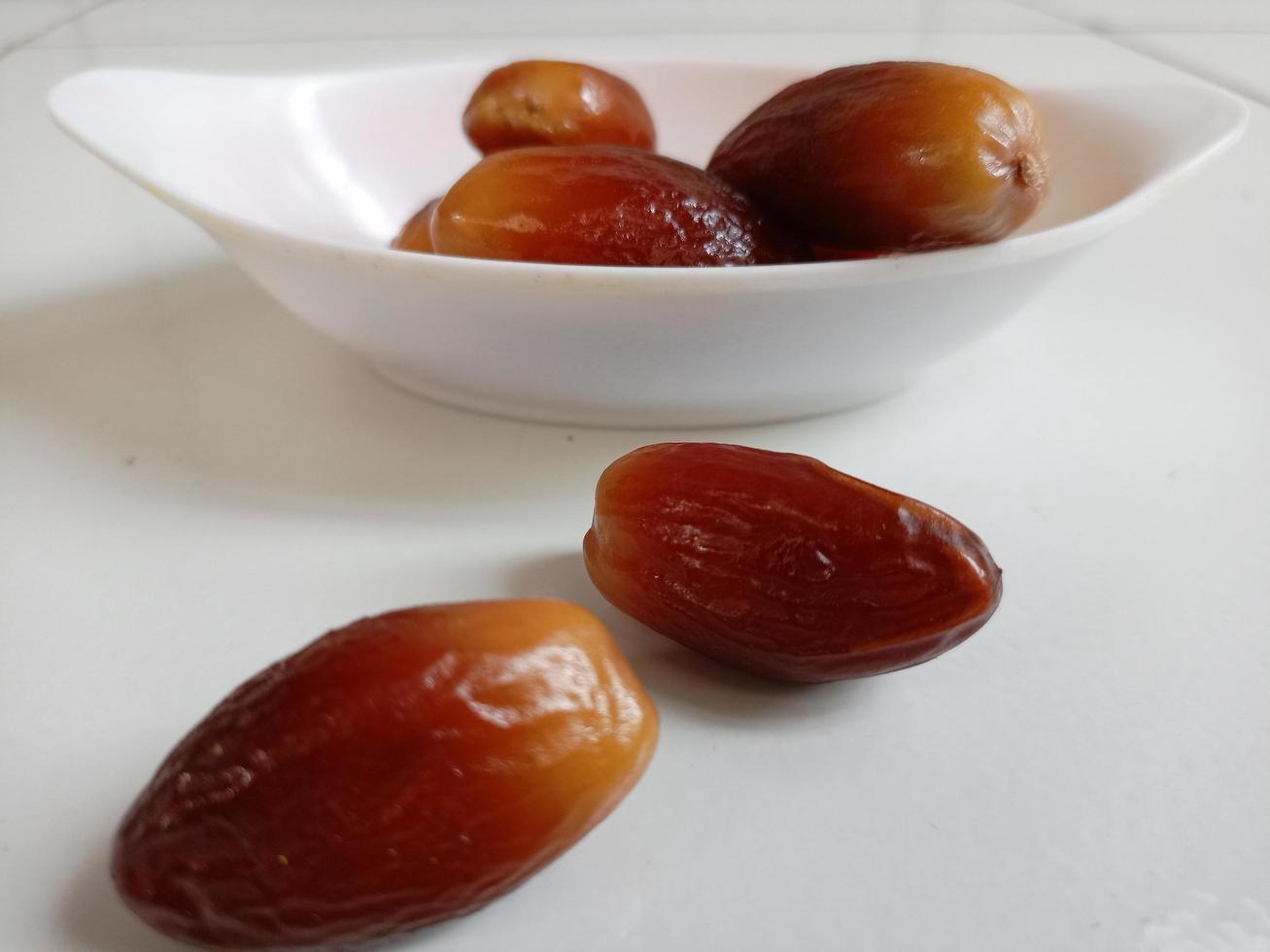 Pile of tasty dry dates isolated on white background. Arabic food photo