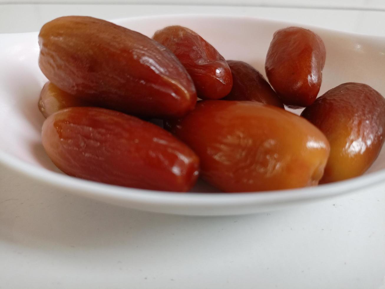 Pile of tasty dry dates isolated on white background. Arabic food photo