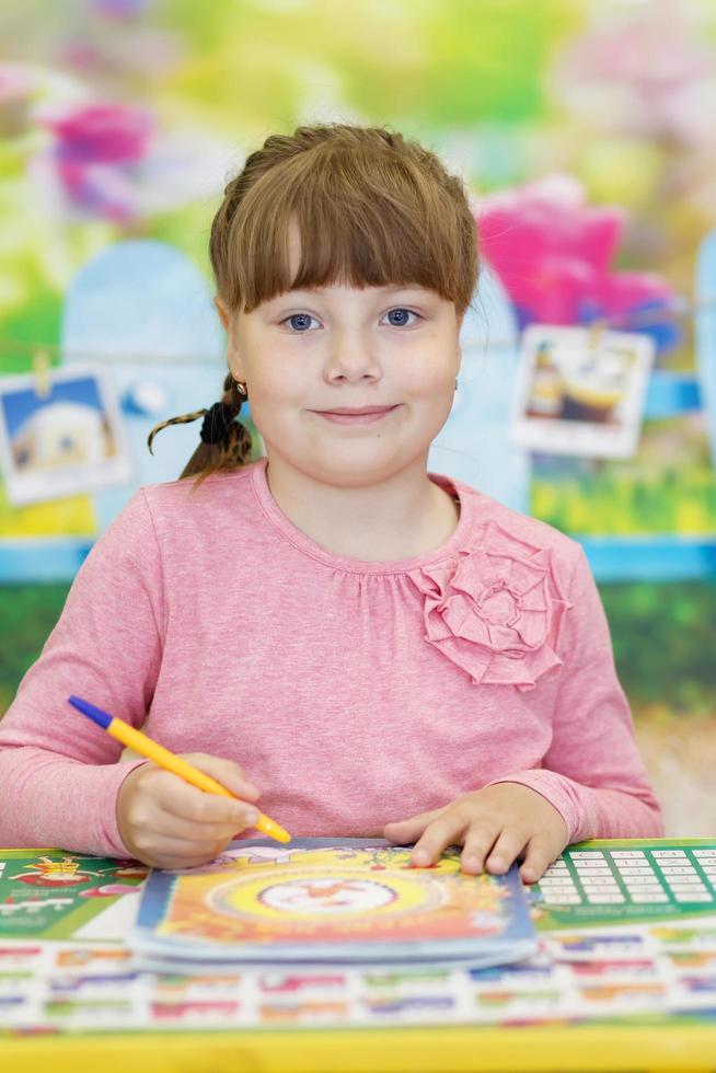 Happy elementary students in classroom at school photo