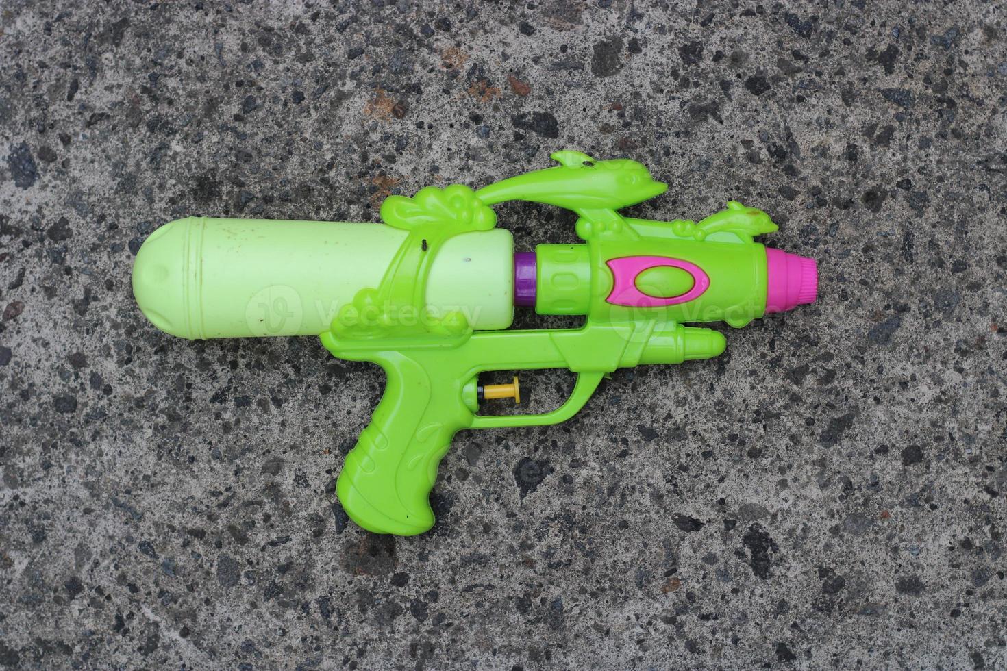 Photo of the green toy gun on the ground