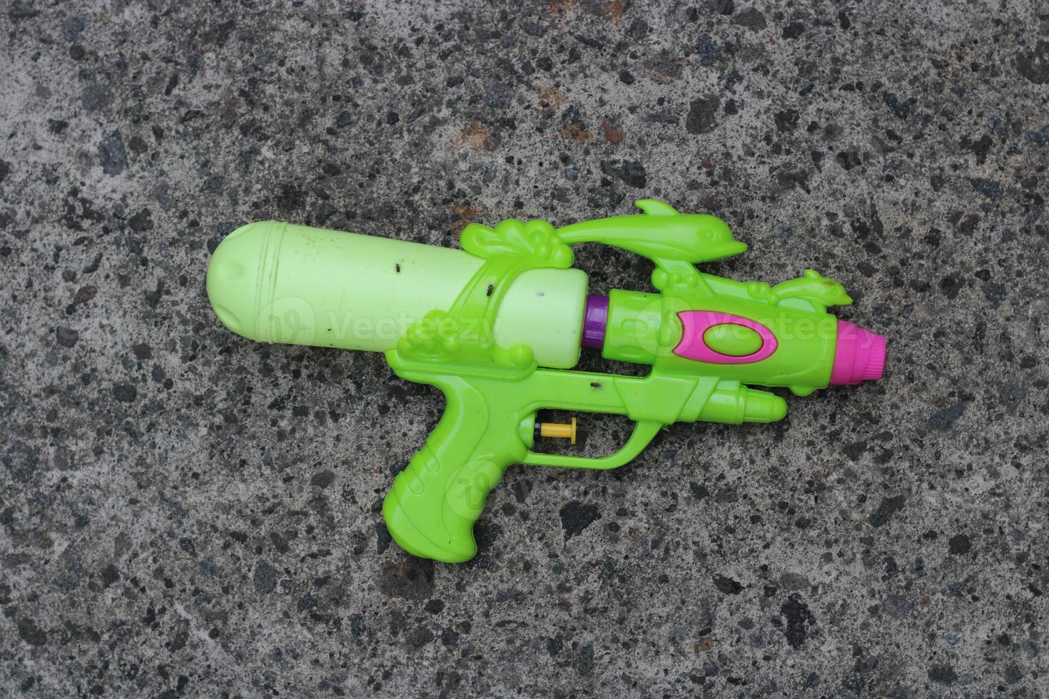 Photo of the green toy gun on the ground