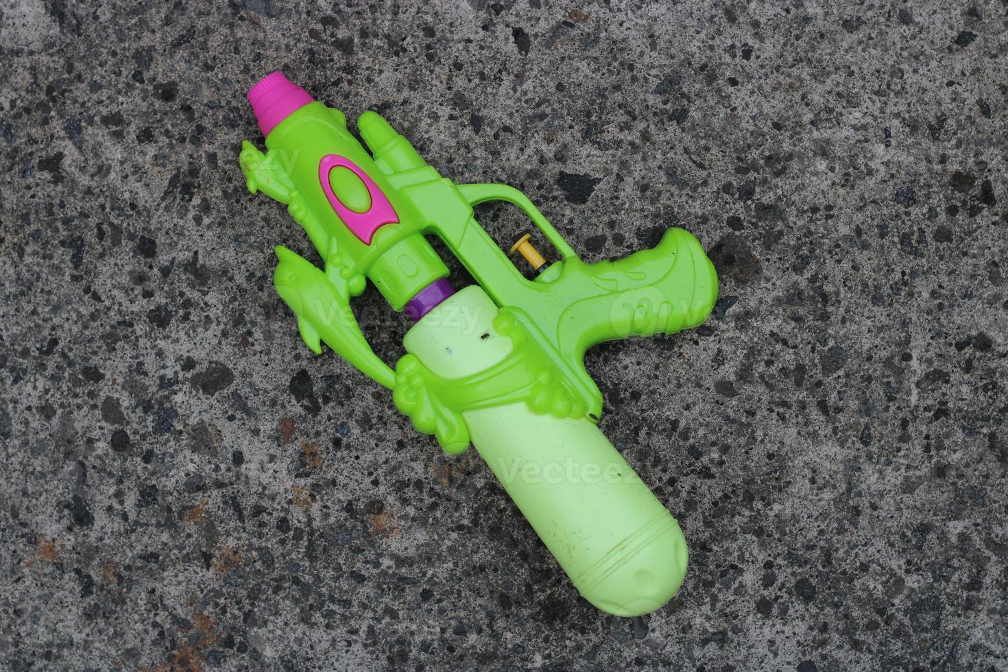 Photo of the green toy gun on the ground