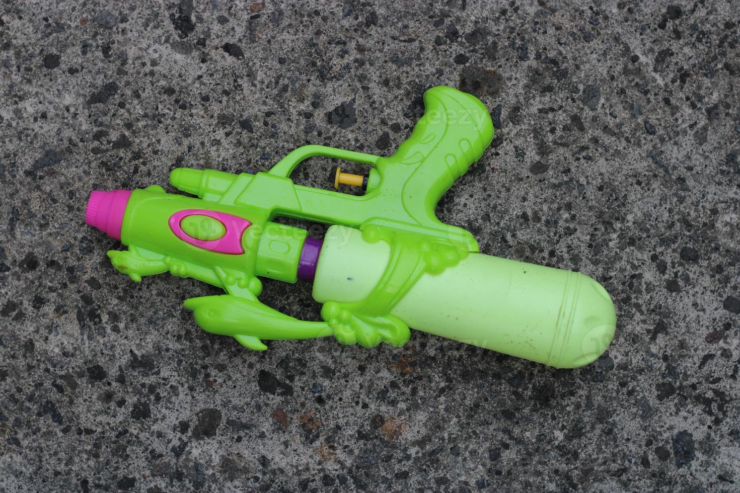 Photo of the green toy gun on the ground