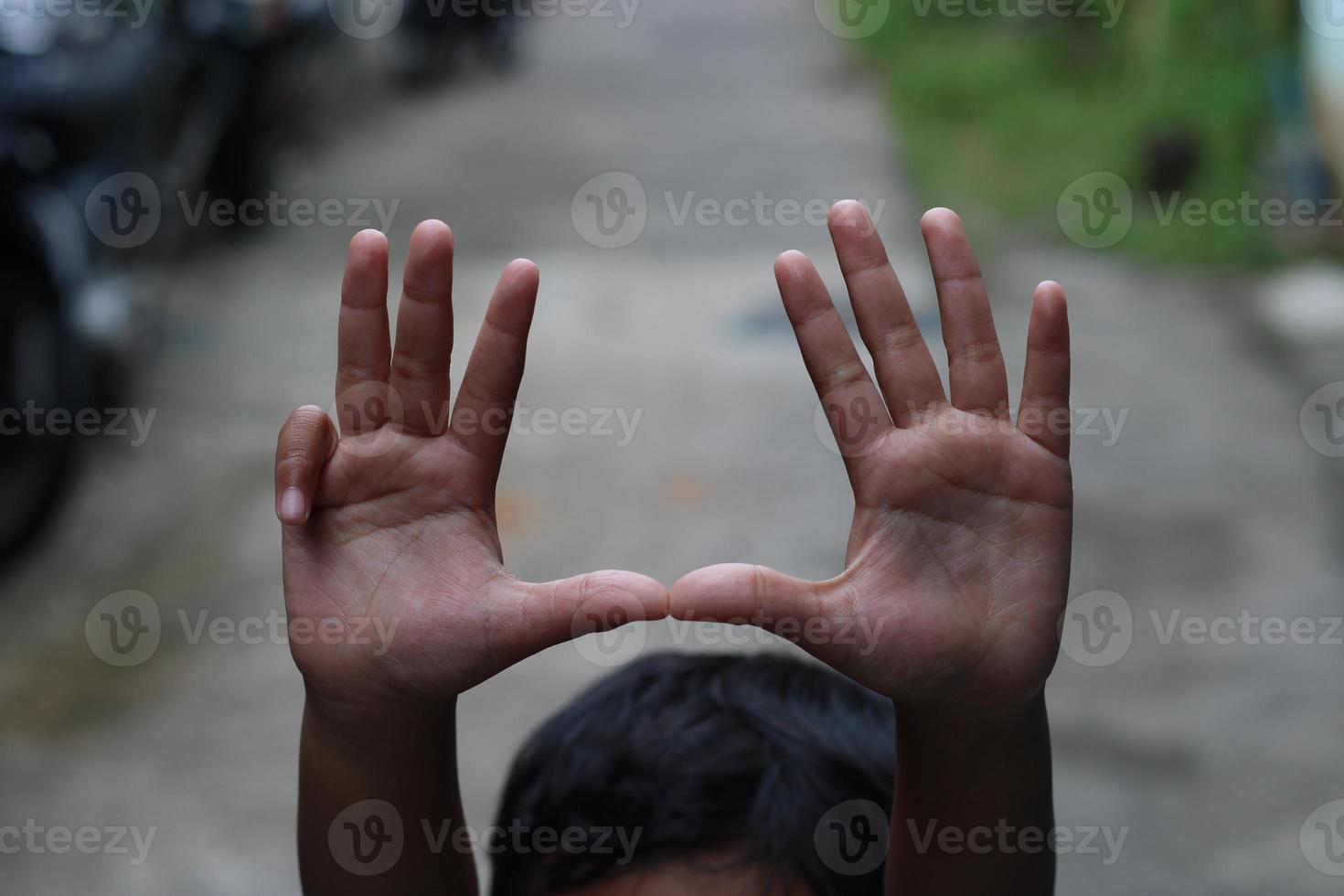 photo of hand waving outside the street