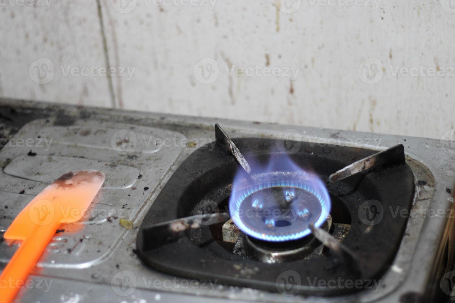 photo of gas stove lighting blue flame