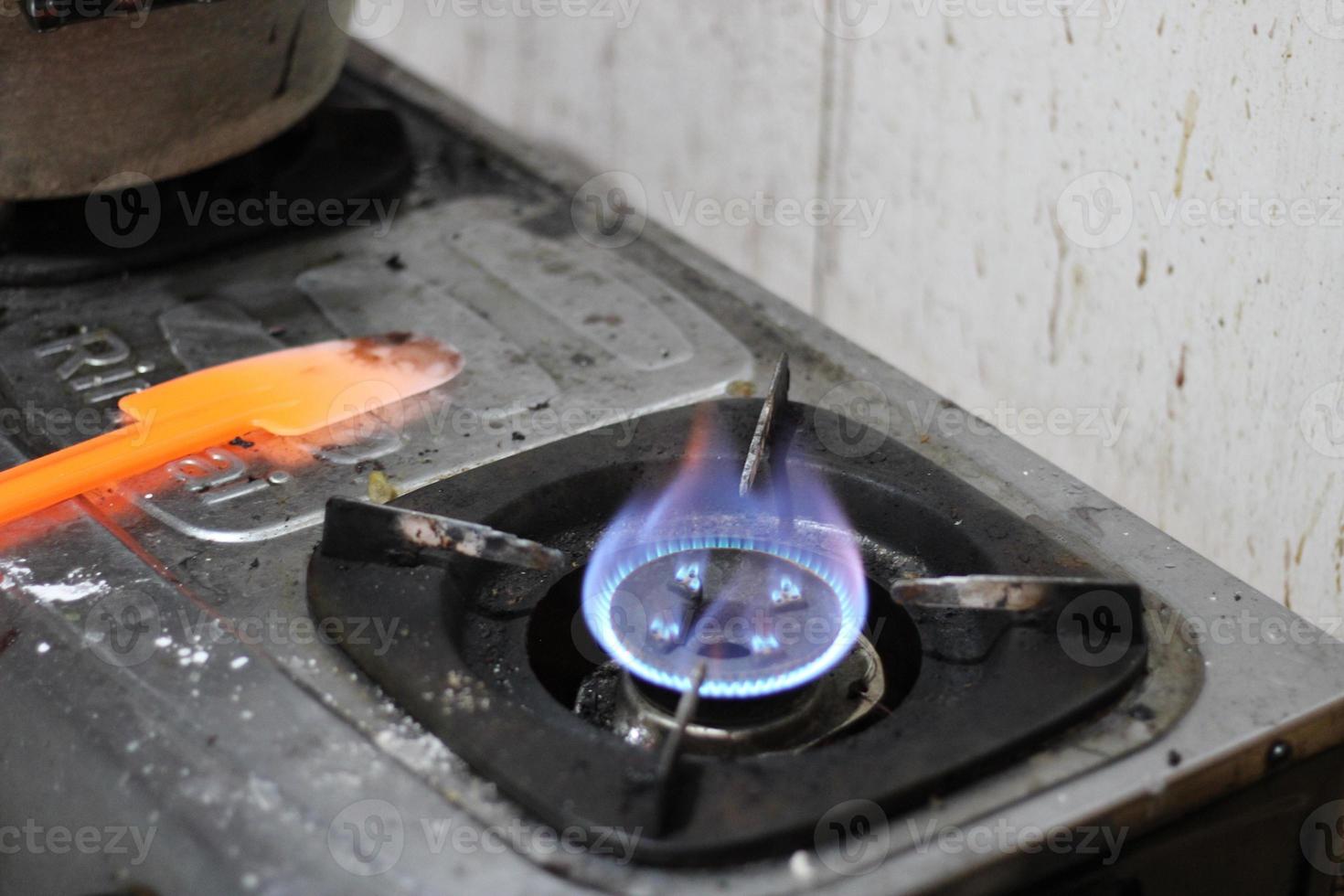 photo of gas stove lighting blue flame