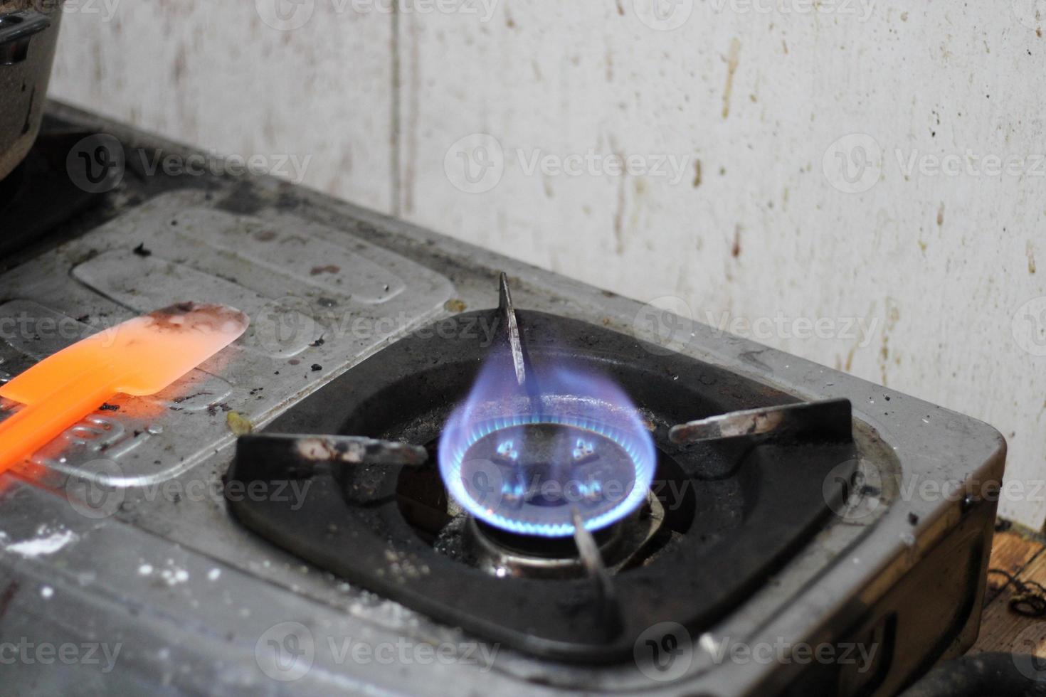 photo of gas stove lighting blue flame