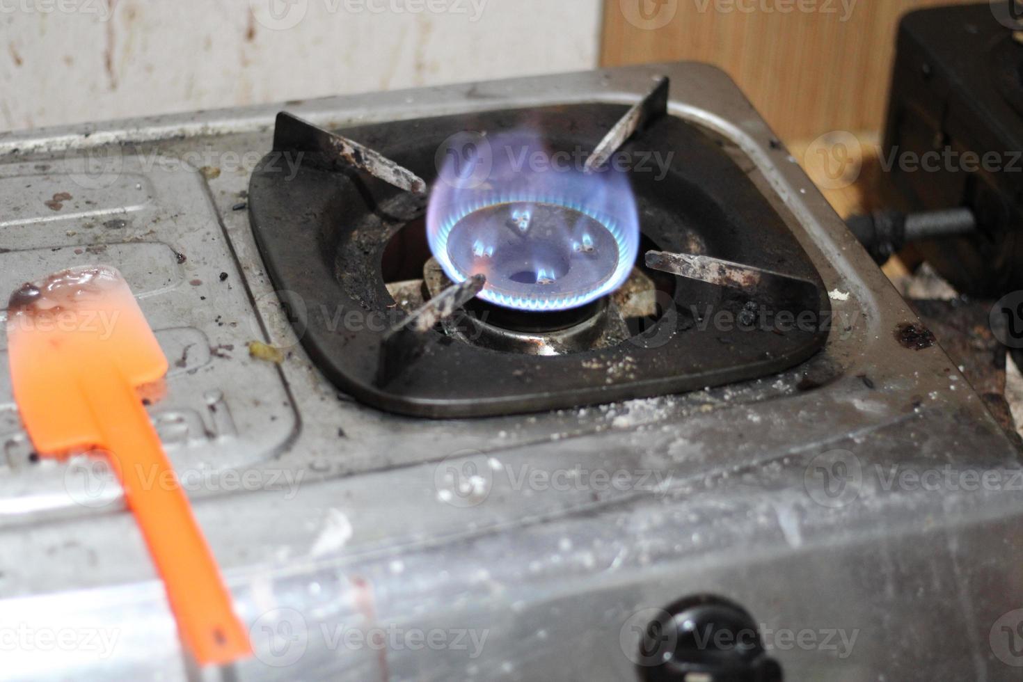 photo of gas stove lighting blue flame