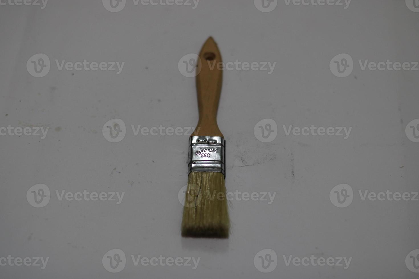 photo of a yellow brush made of wood with a white background