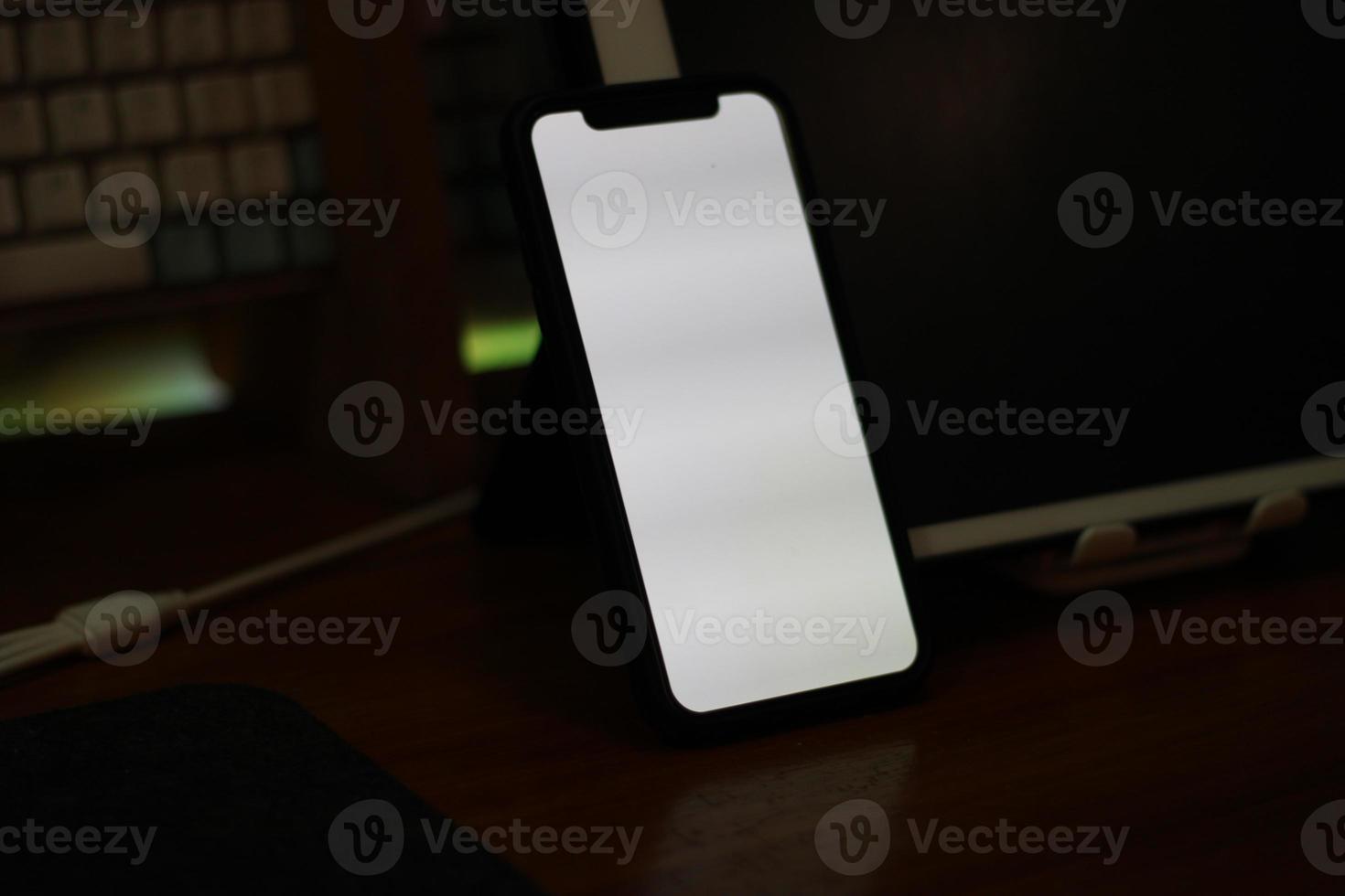 Photo of an empty cell phone with white screen on the table