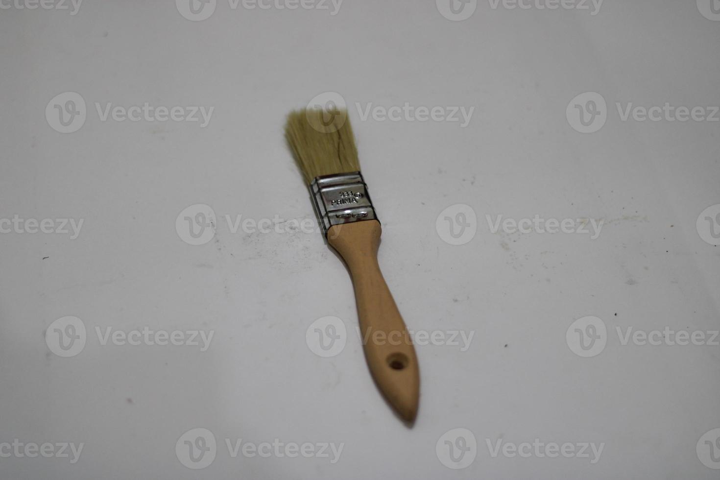 photo of a yellow brush made of wood with a white background