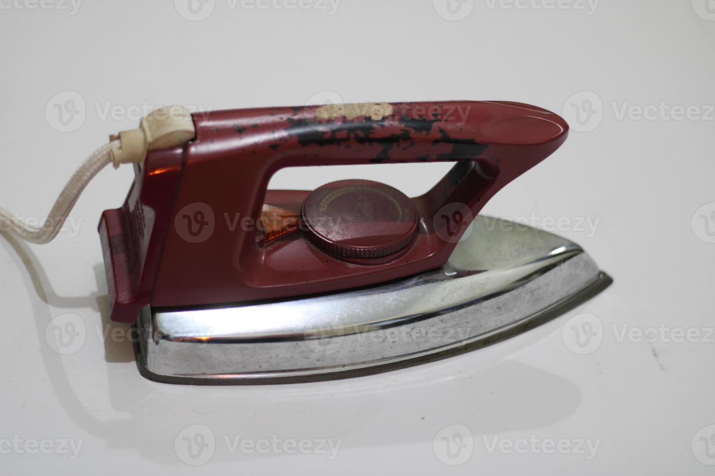 photo of an old silver red iron