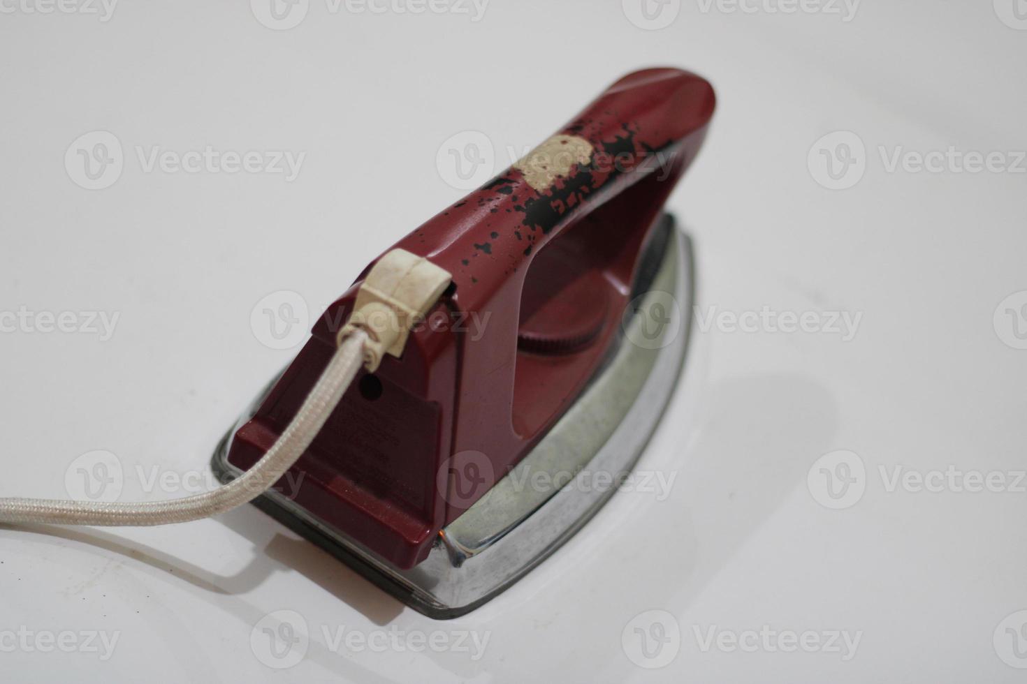 photo of an old silver red iron