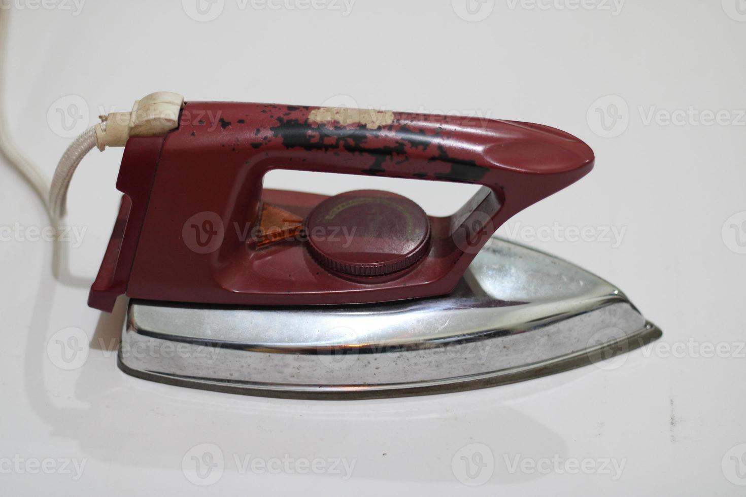 photo of an old silver red iron