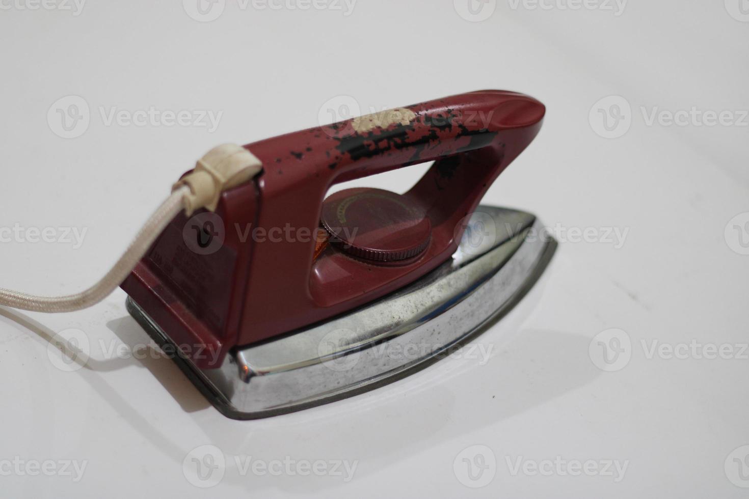 photo of an old silver red iron