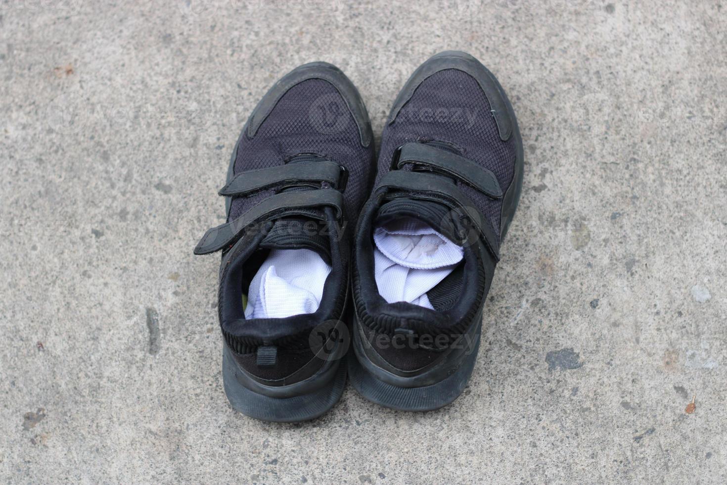 photo of black shoes worn on the street