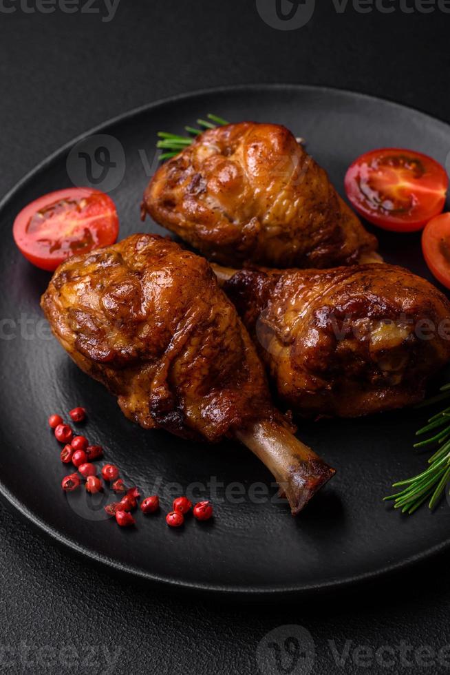 Delicious grilled chicken legs with spices and herbs in teriyaki sauce photo