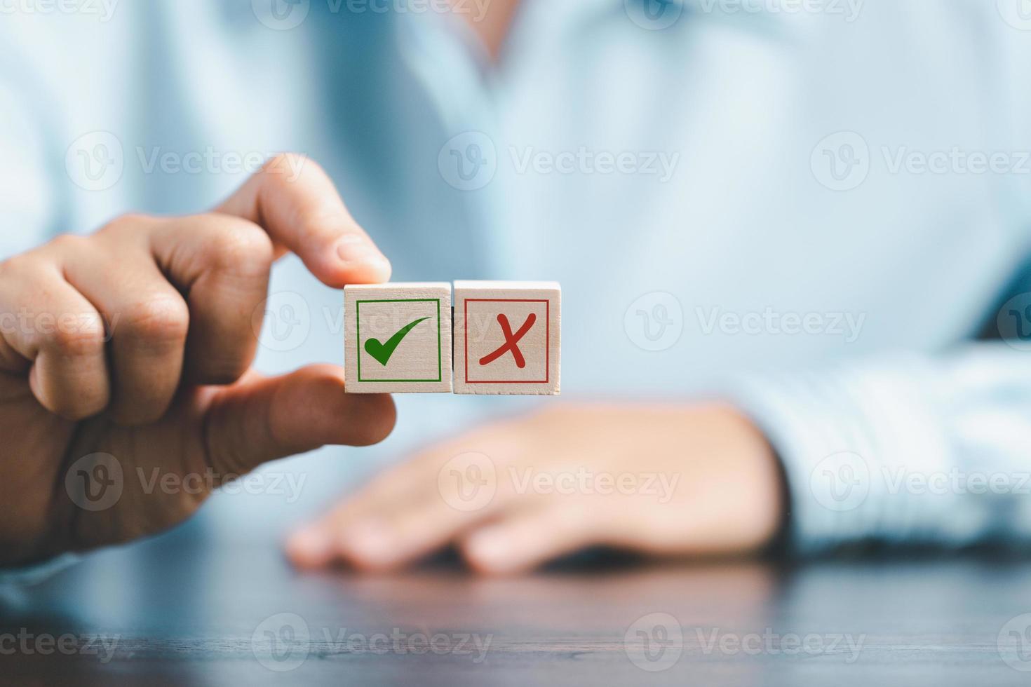 concept of right or wrong mark on wooden cubic blocks. Business and lifestyle concept. Think With Yes Or No Choice, Business Choices For Difficult Situations, wooden with right or wrong mark on it. photo