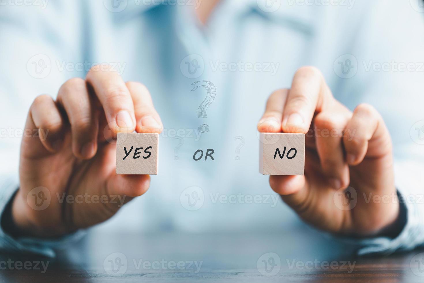 Concept of choice yes or no on wooden cubic blocks. Think with Yes or No choice, Business choices for difficult situations, Business woman hands holding two wooden with yes or no word on it. photo