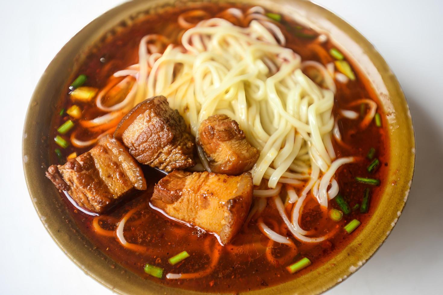 Chicken noodle soup and braised pork noodles are common food in China photo