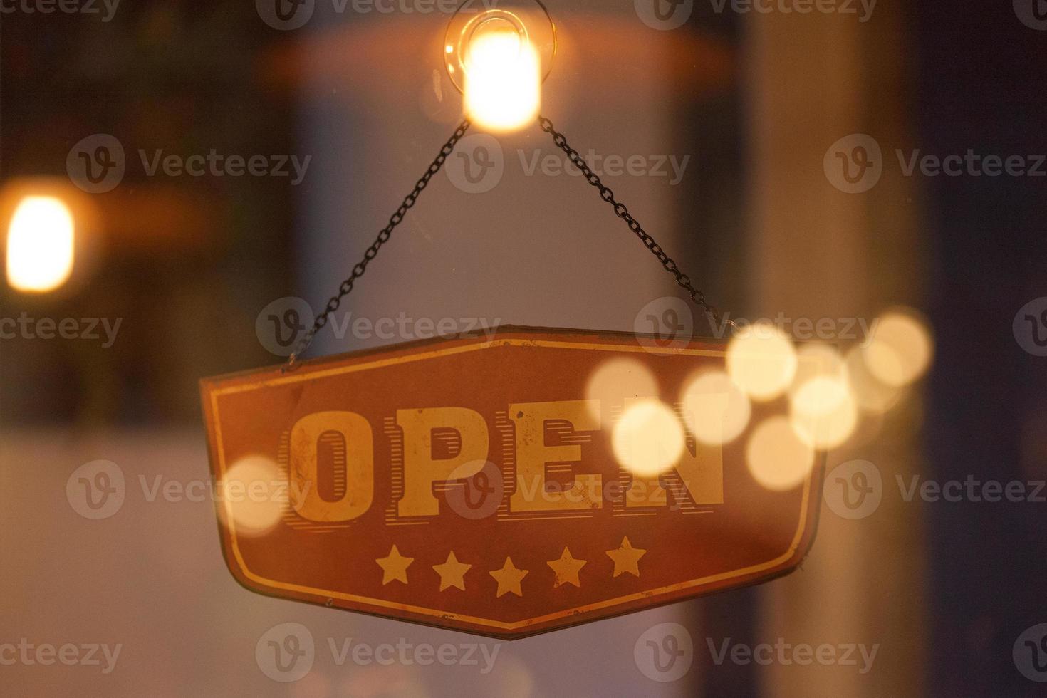 Open sign in the window of a shop photo