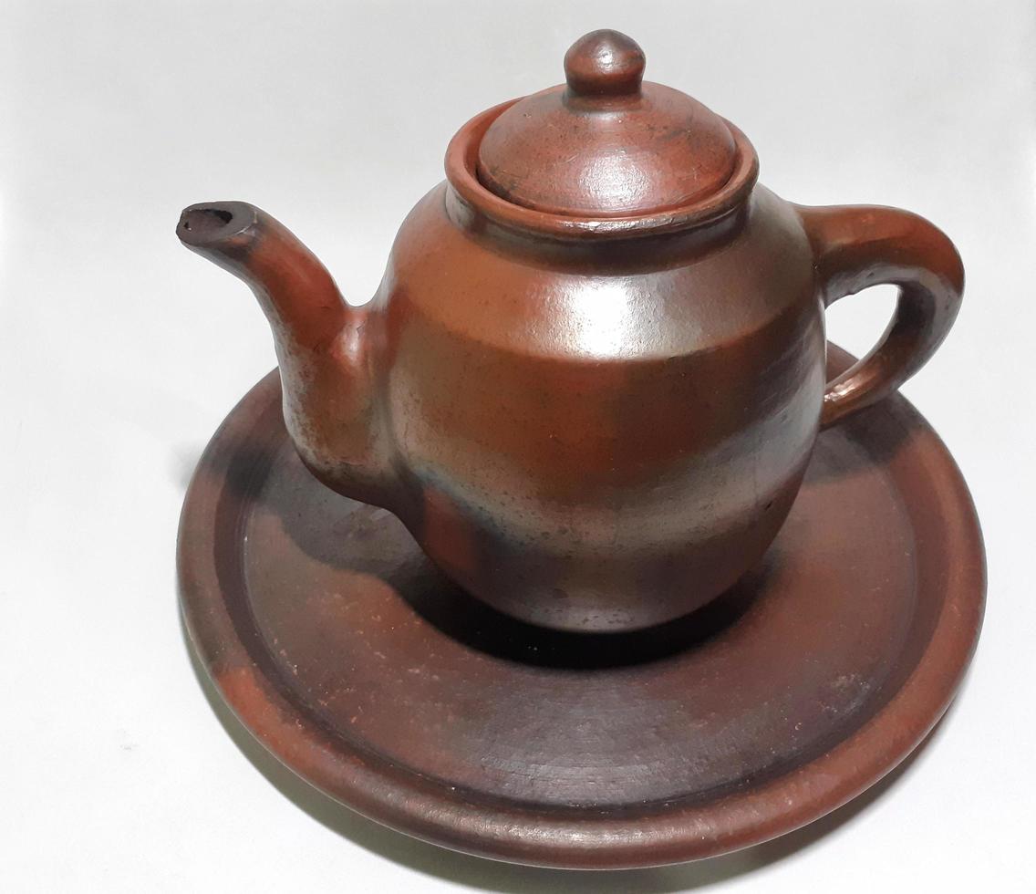 Clay teapot isolated on grey  background. photo