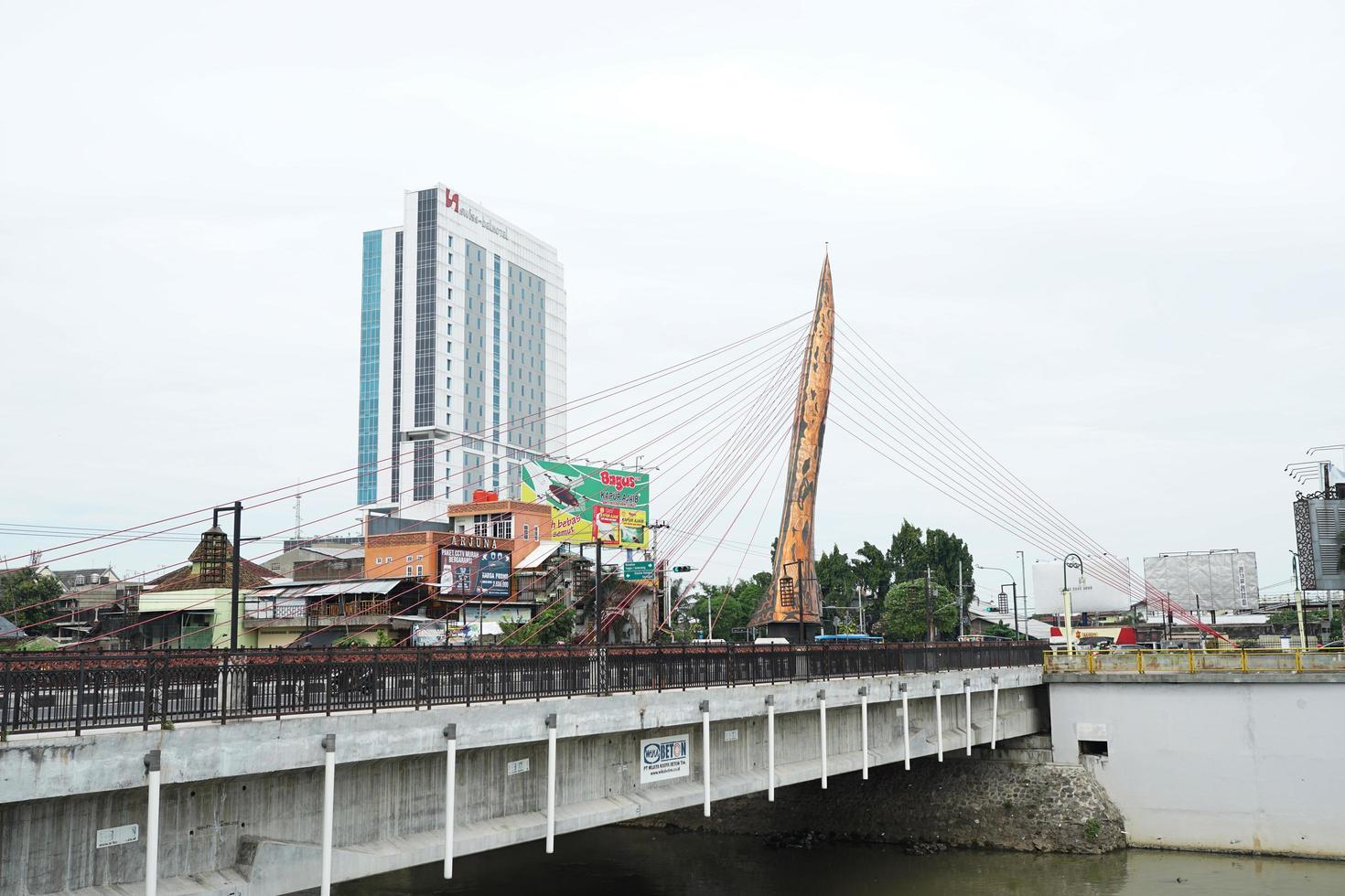SOLO, INDONESIA - July 16, 2022 panoramic view of the city of solo, Bengawan Solo with the keris monument bridge in front of the Tritonadi terminal photo