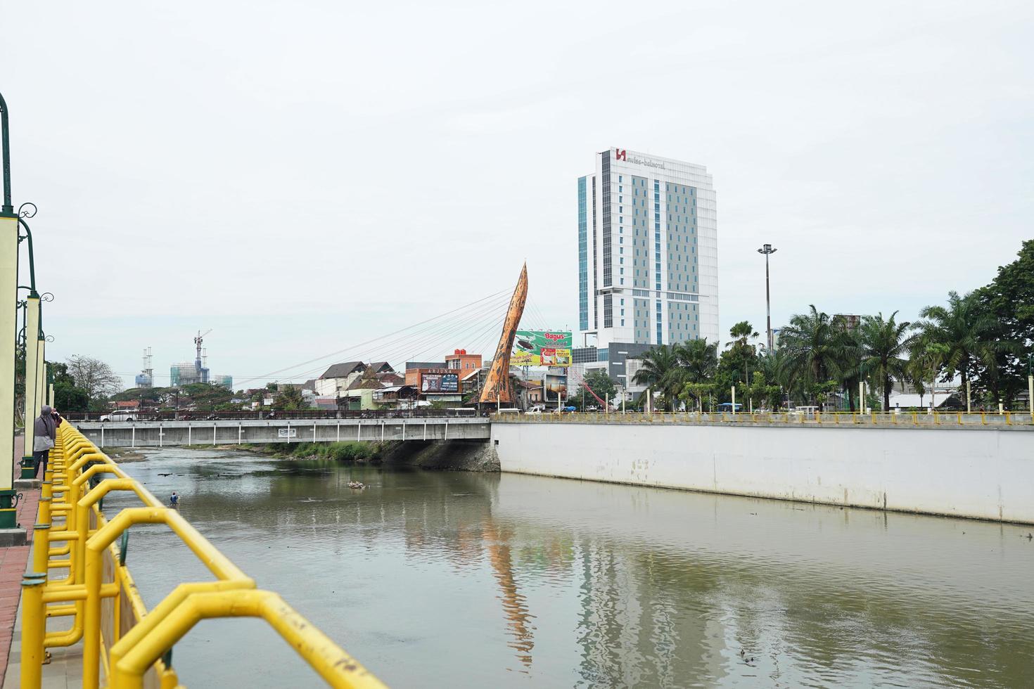 SOLO, INDONESIA - July 16, 2022 panoramic view of the city of solo, Bengawan Solo with the keris monument bridge in front of the Tritonadi terminal photo