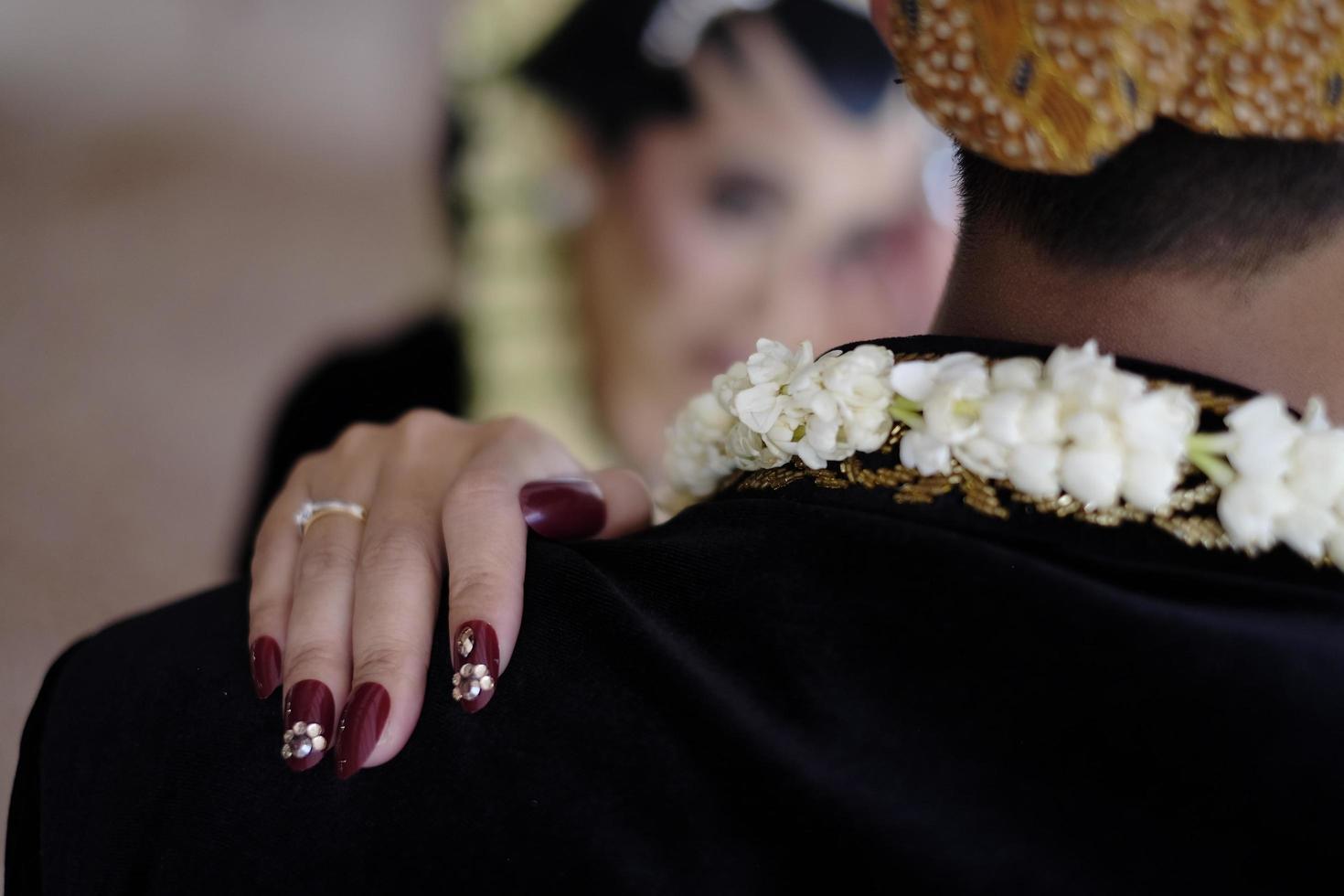 Solo, Indonesia - February 20, 2023 the wedding moment tells of curling fingers with rings photo