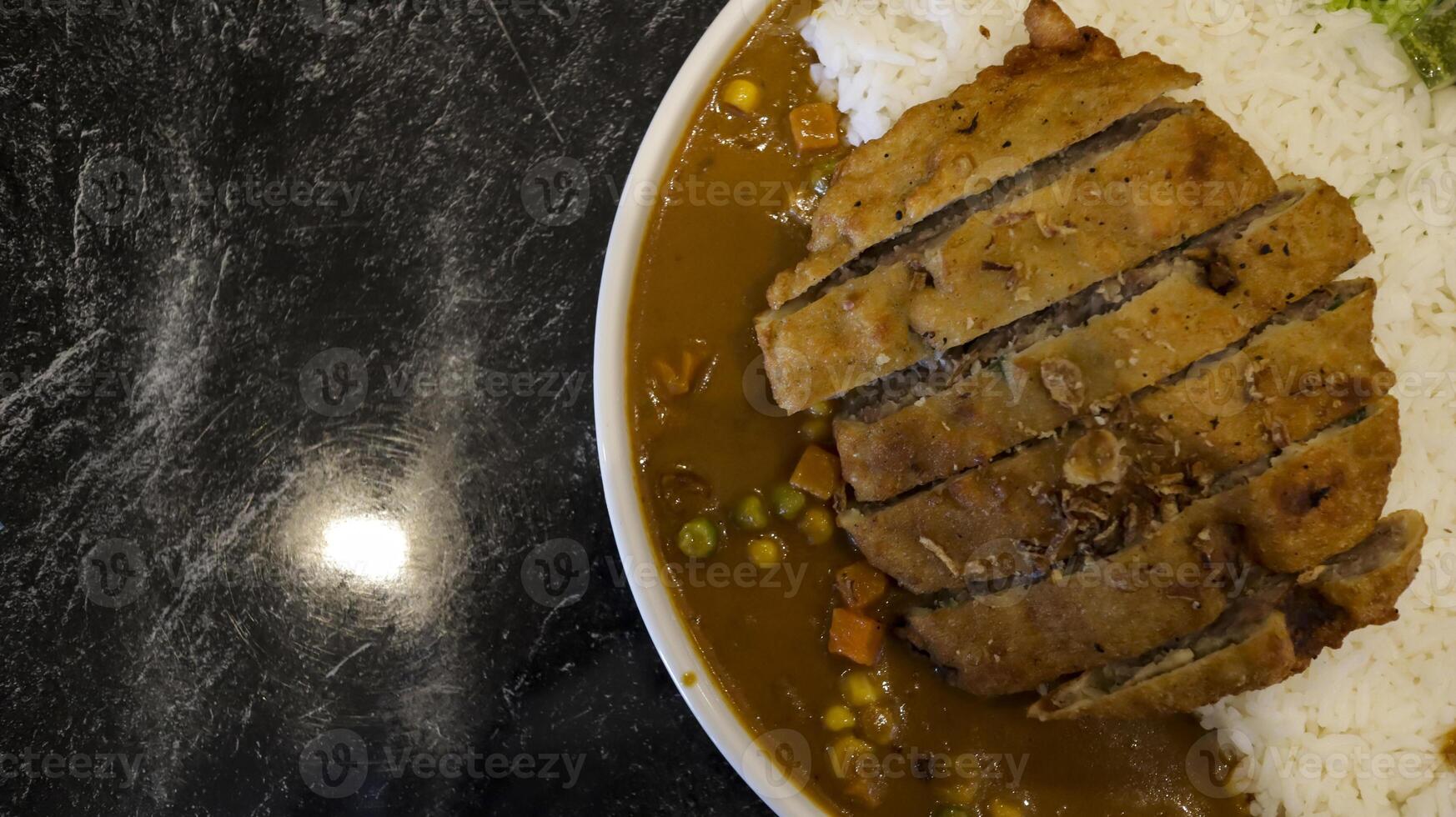 English chicken schnitzel curry with rice and good plating presentation. Thin slice of meat chicken breasts that is breaded and fried, popular dish in Germany. Flay lay, copy space. photo