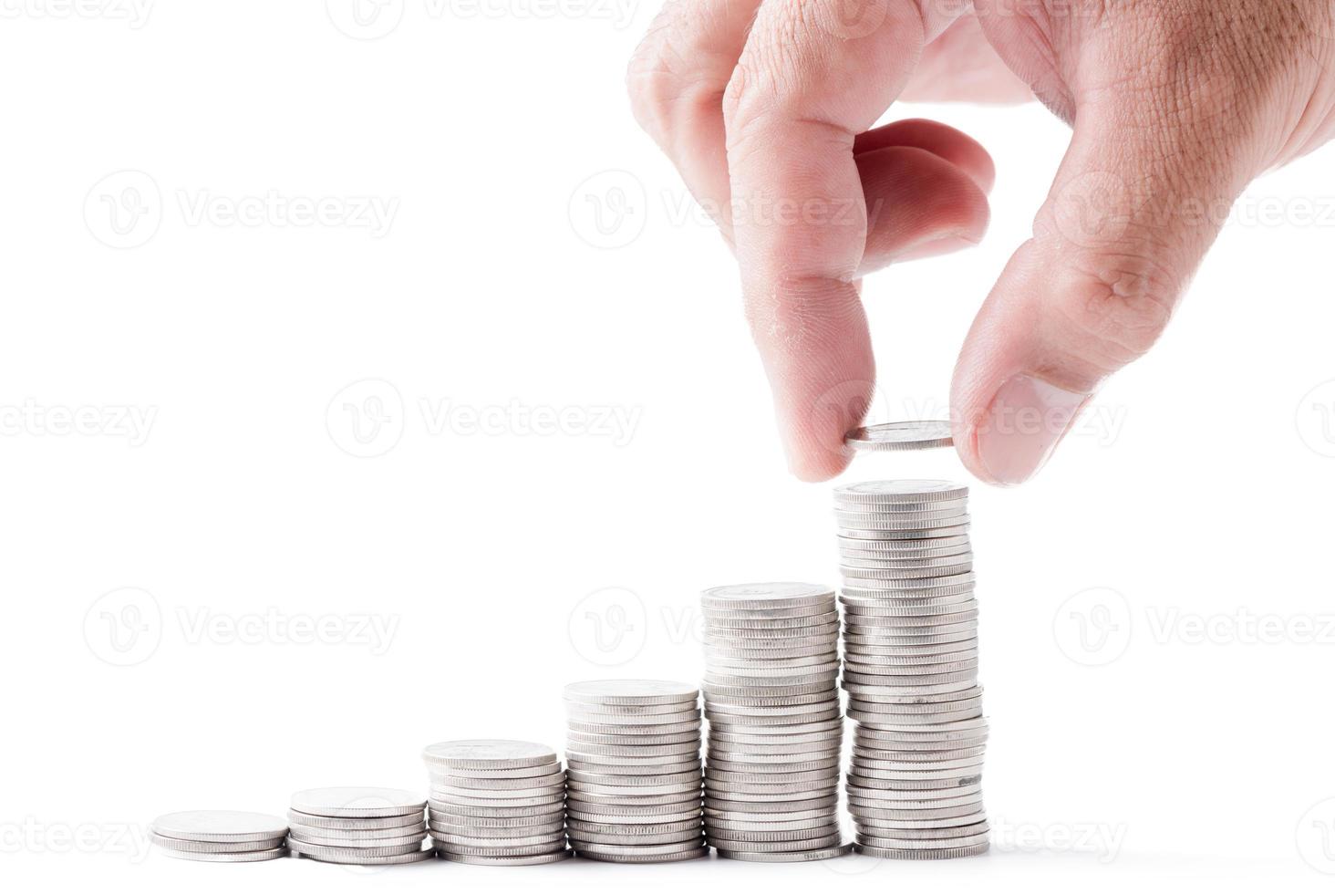 business man hand put coin to cion stacked isolated photo