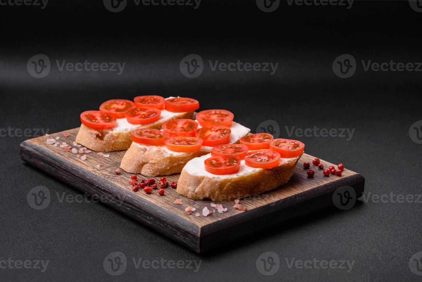 Delicious crispy grilled toast with cheese and cherry tomatoes photo