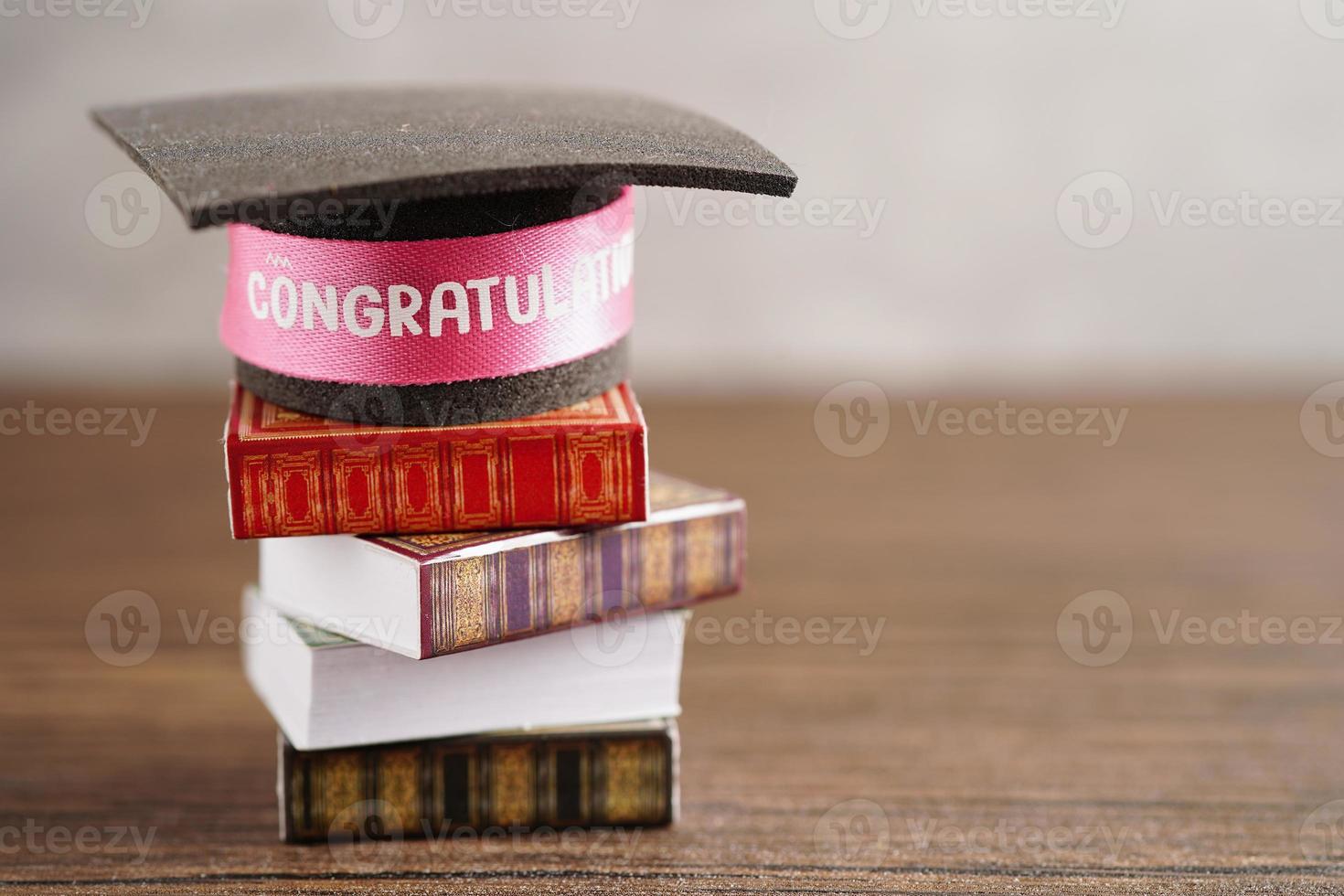 Graduation hat on book with copy space, learning university education concept. photo