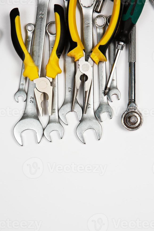 Set of tools for repair in a case on a white background. Assorted work or construction tools. Wrenches, Pliers, screwdriver. Top view photo