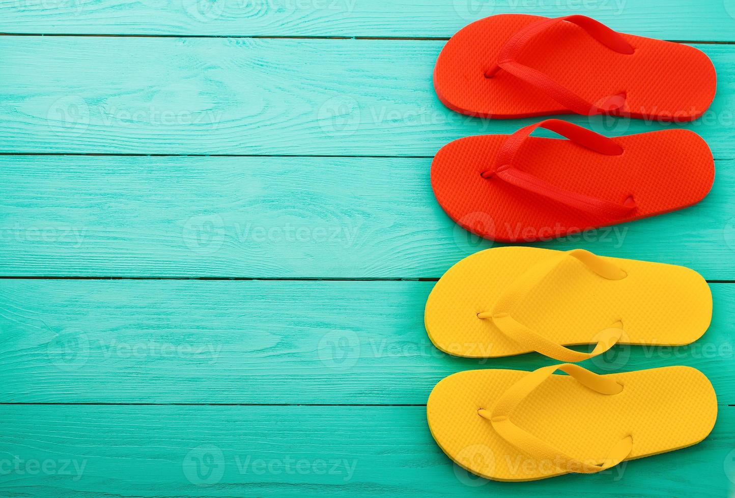 flip flops on blue wooden background with copy space. Top view. Mock up. Summer shoes sandals. Slippers photo