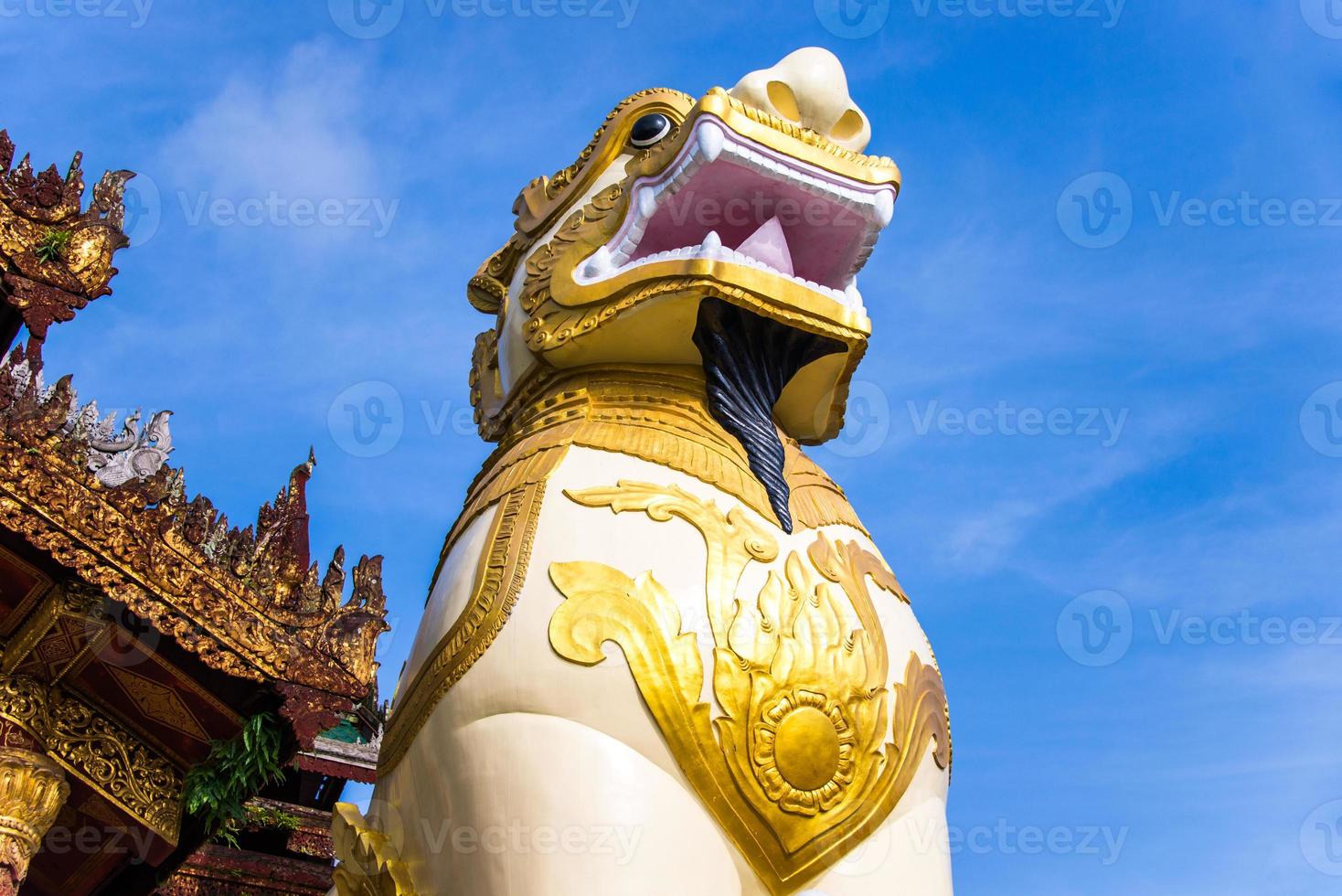 The spirit of lion statue at the gate of temple photo