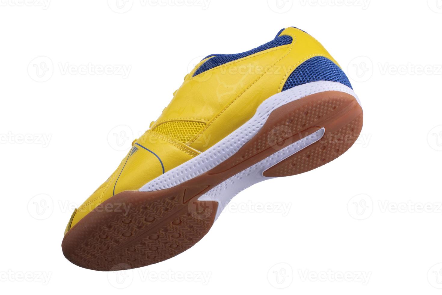 Yellow sneakers with blue accents on a white background. photo