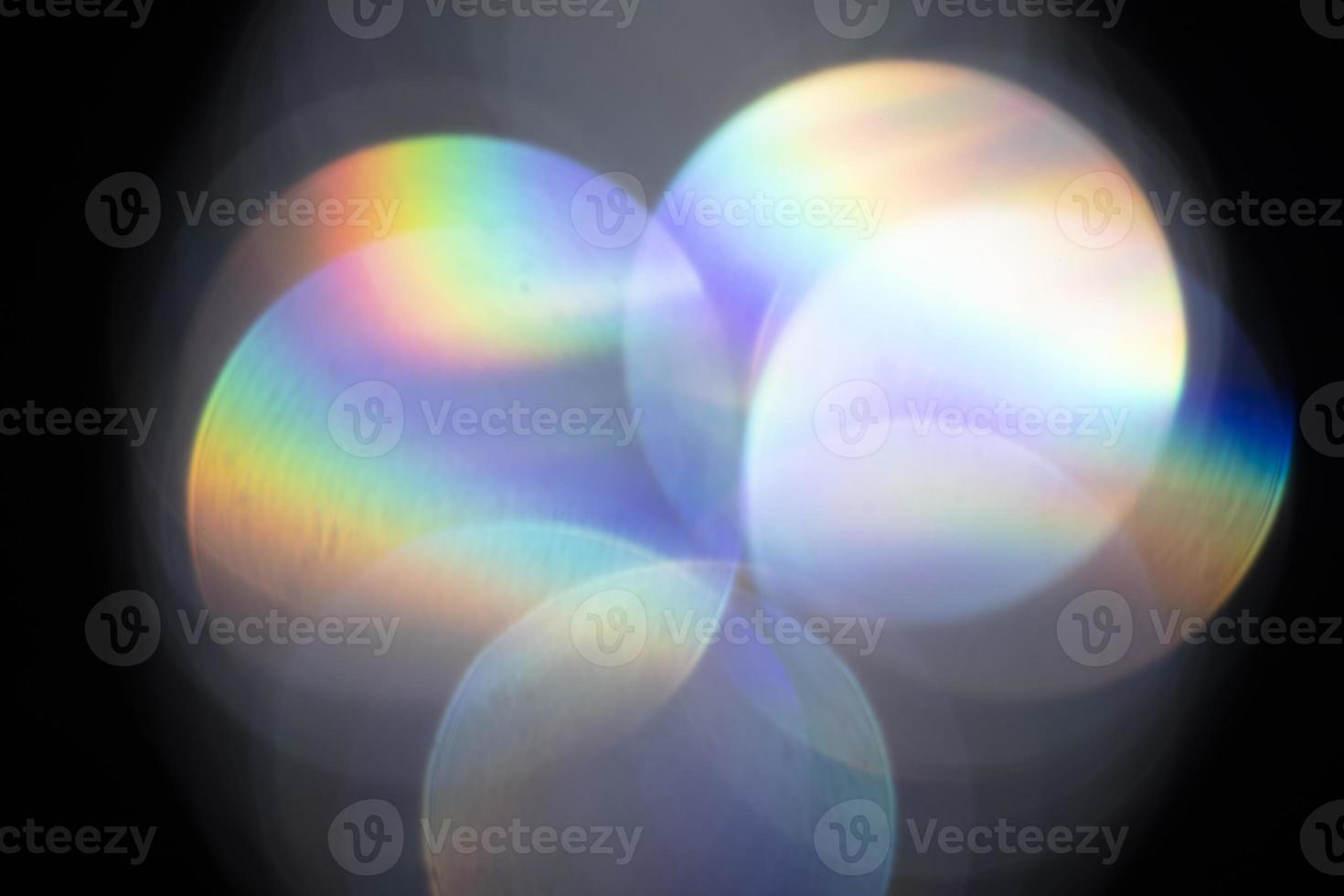 Lens flare, Bokeh lights. Reflections from glass, diamond, crystal. Defocused shining colorful rainbow light leaks, rays on black background photo