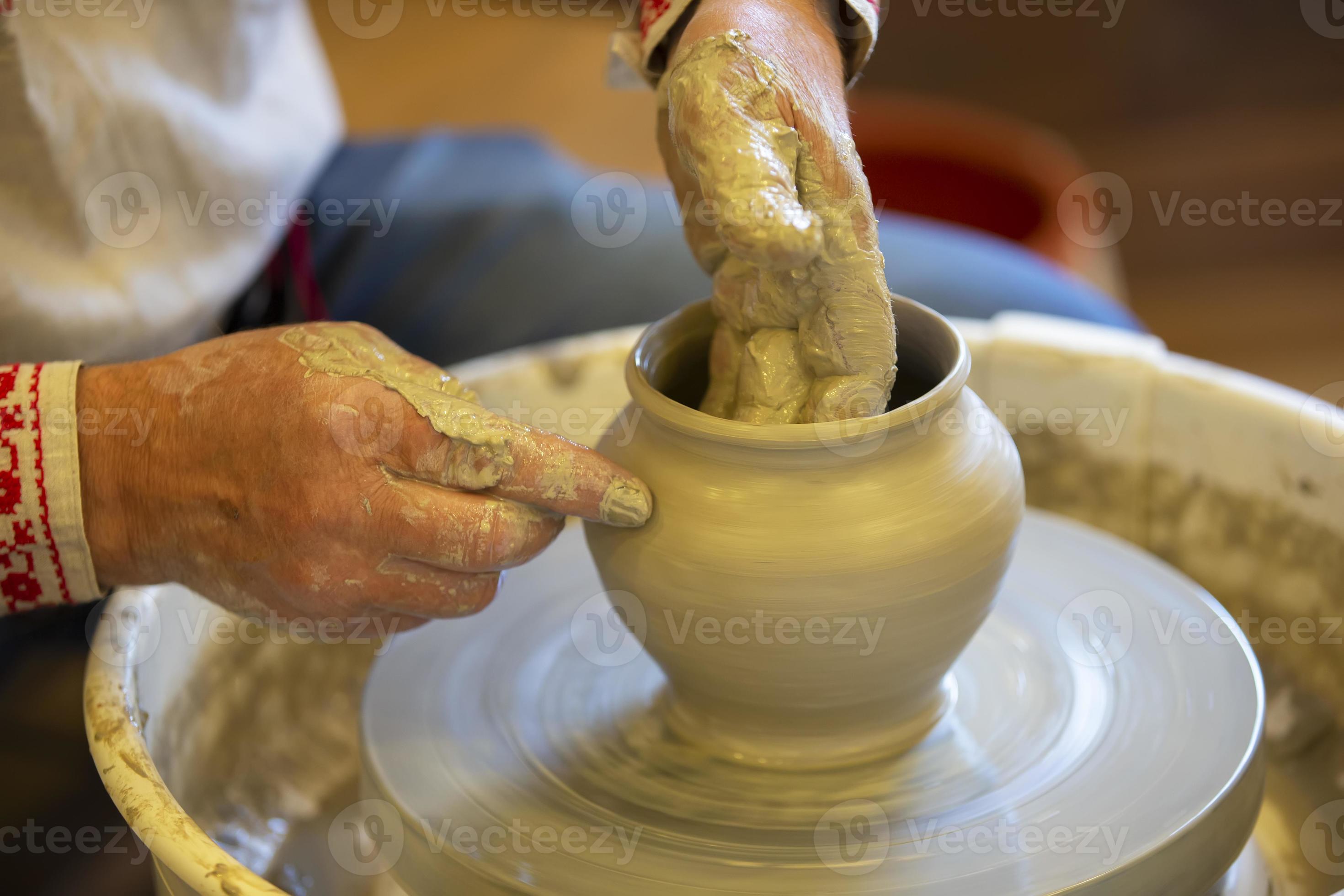 The hands of an artisan make a clay pot. Making clay products. 22947976