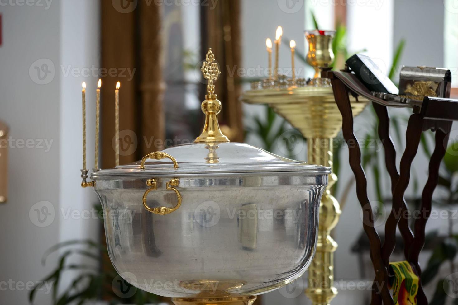 The interior of the church during the baptism of a child. Bath for baptism. photo