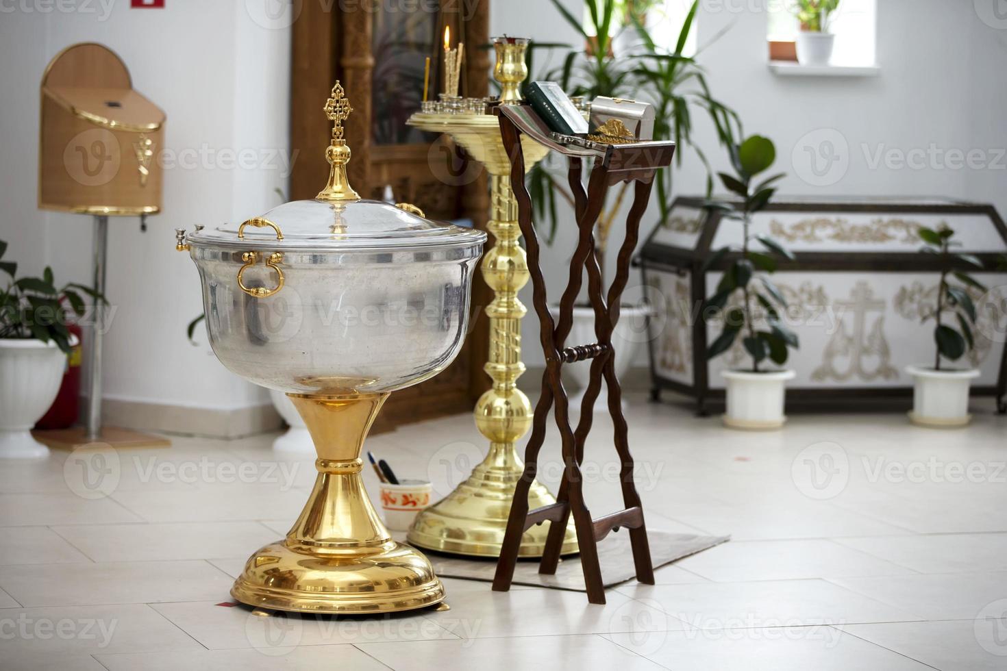 The interior of the church during the baptism of a child. Bath for baptism. photo