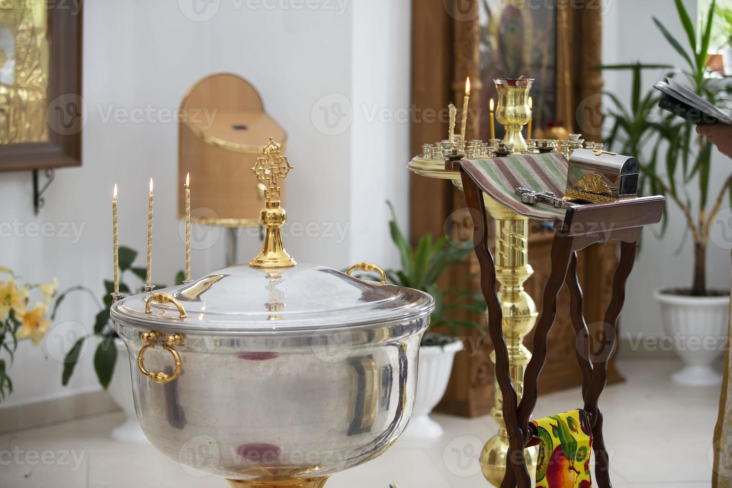 The interior of the church during the baptism of a child. Bath for baptism. photo