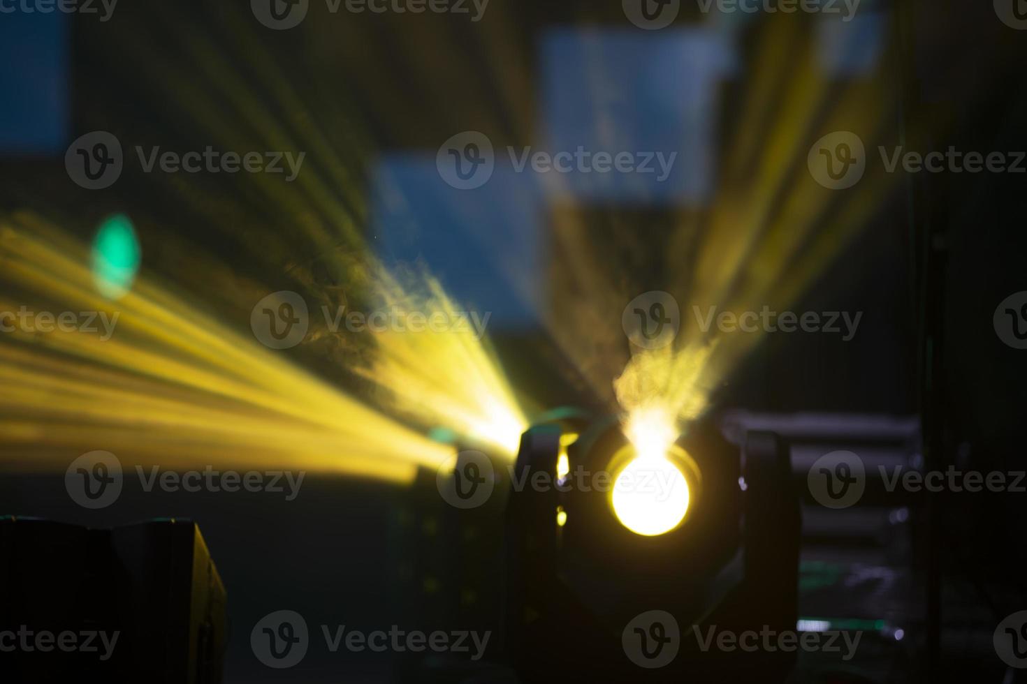 Yellow light of concert spotlights.Beautiful stage background with rays. photo