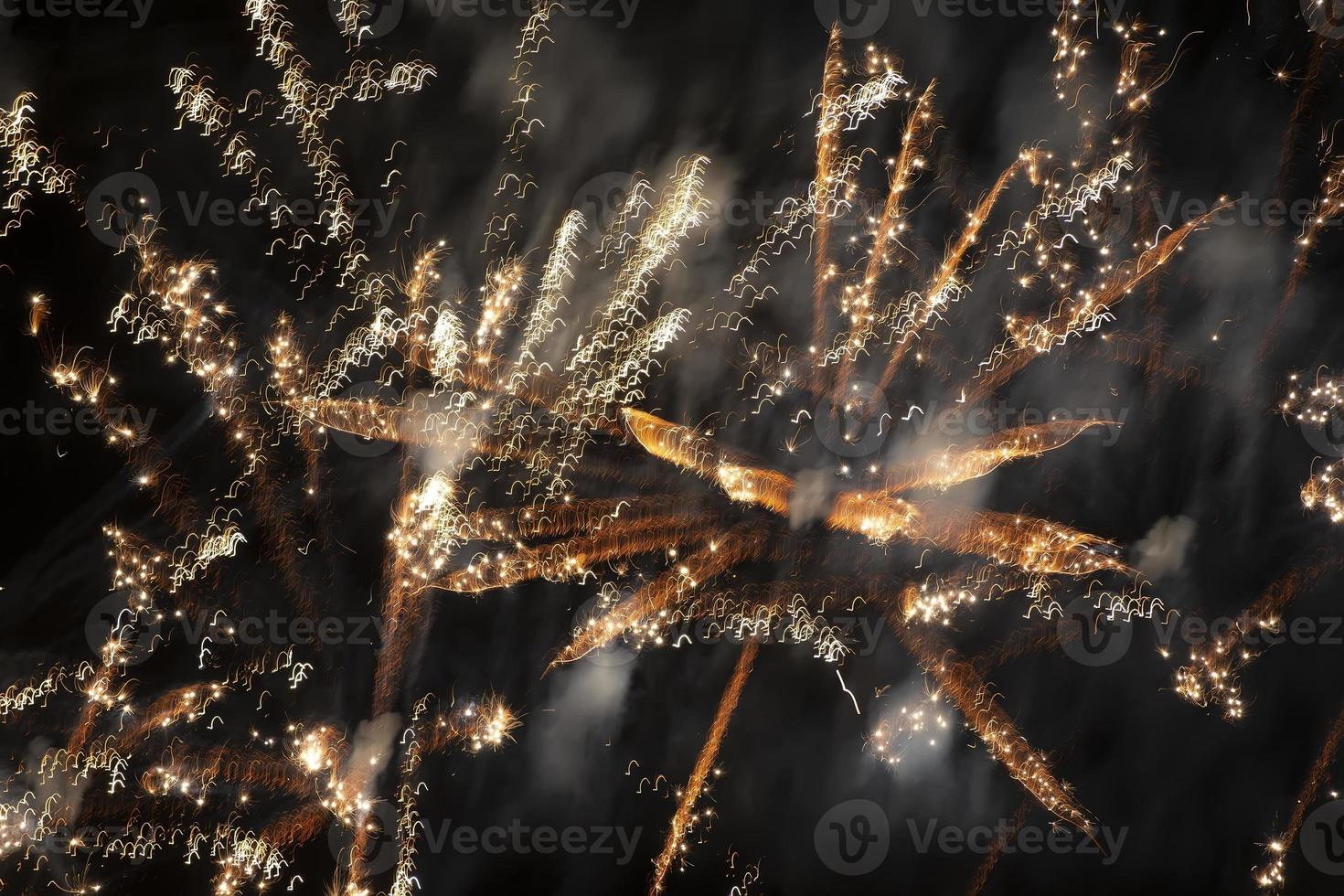 Blurred golden fireworks lights on a black background. photo