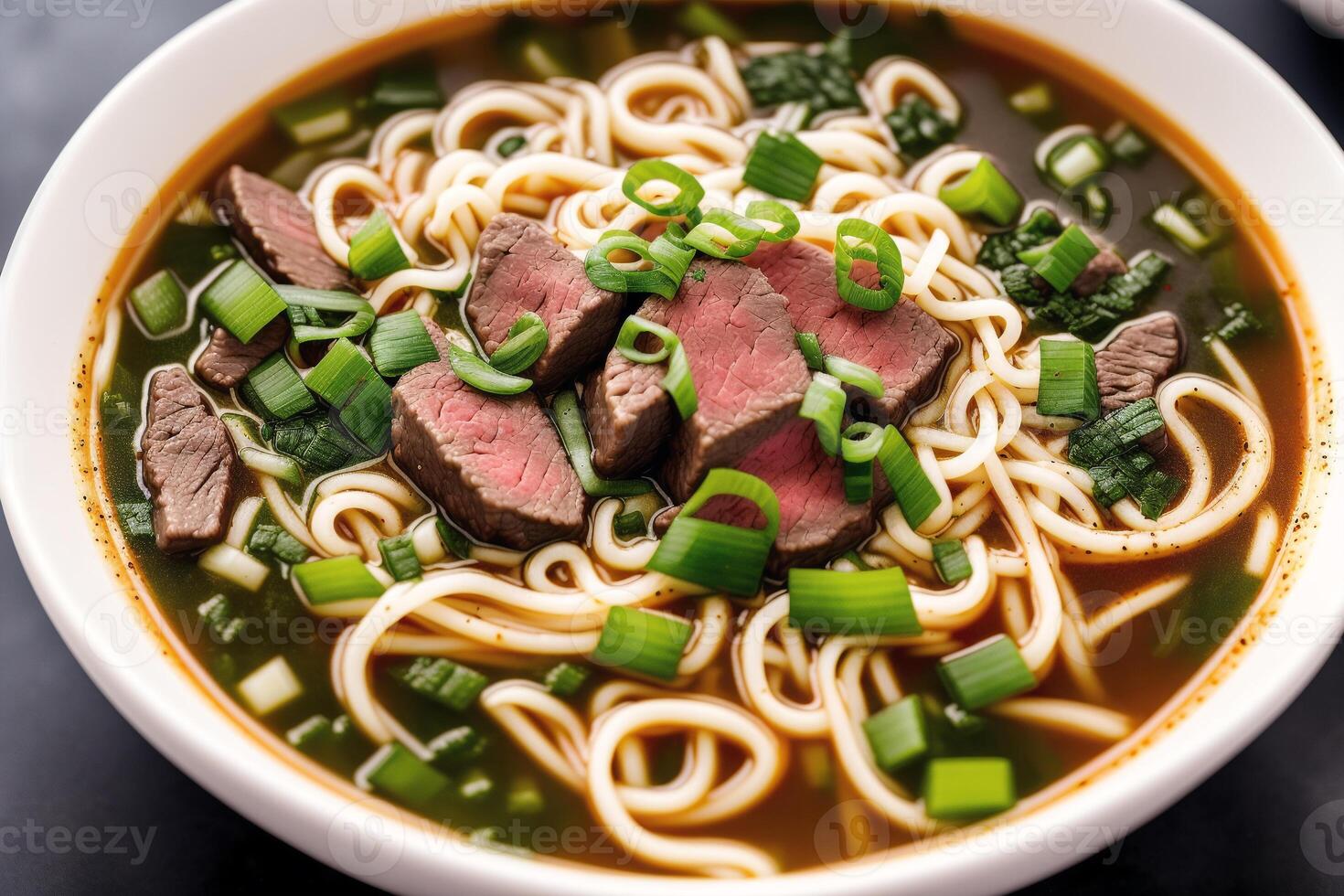 Japanese ramen noodle soup with beef and green onion in bowl. Beef soup. photo