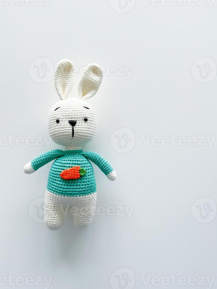 Soft white crochet bunny. on a white background. photo