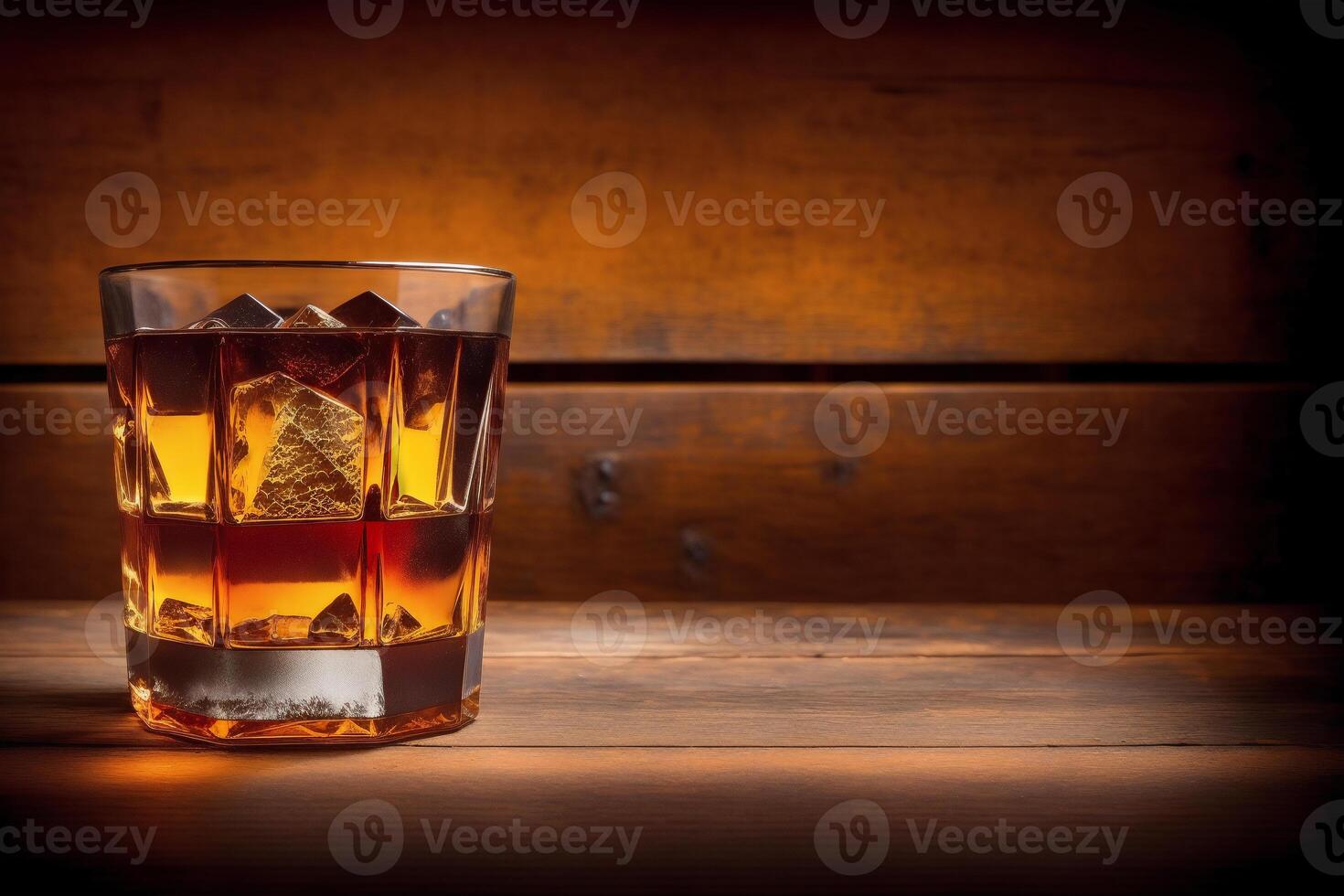 Glass of whiskey on the rocks with ice cubes on a wooden table, close-up. photo