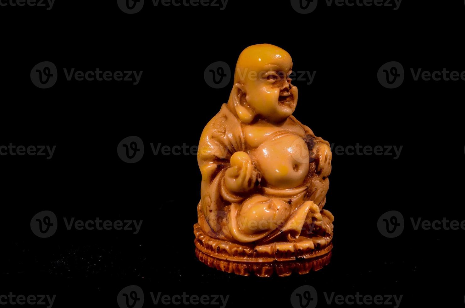 Buddha sculpture on black background photo