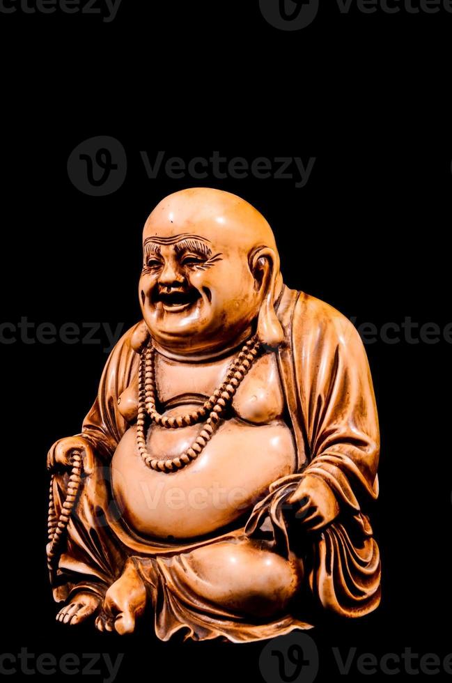 Buddha sculpture on black background photo